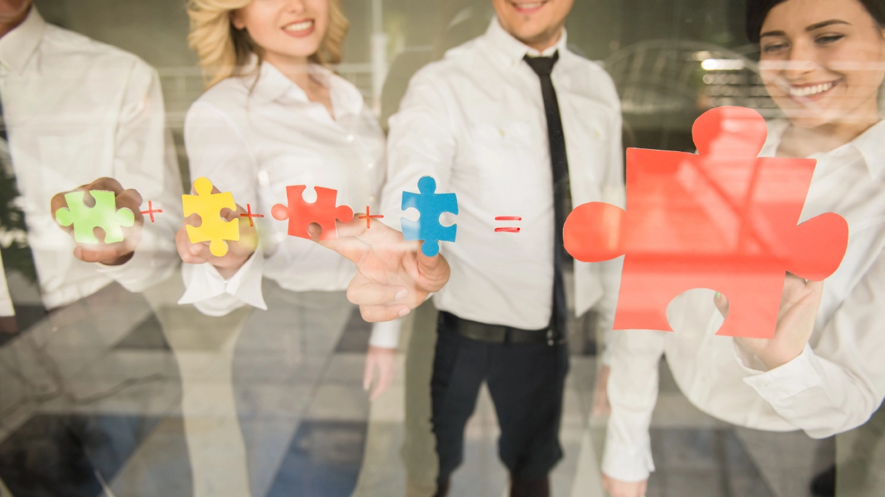 Group of business people assembling jigsaw puzzle and represent team support and help concept.<br />